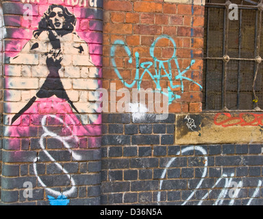 Urban graffiti street art of glamorous woman on brick wall east London England Europe Stock Photo