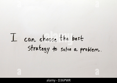Lesson for school or work application written by hand in good penmanship on a white board: I can choose the best strategy to solve a problem. Stock Photo