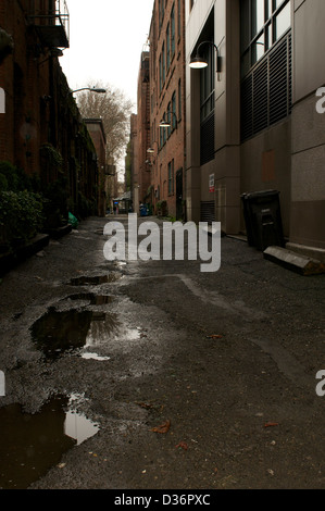 Puddles in city alley Stock Photo