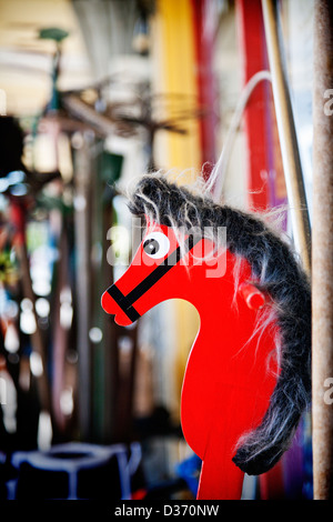 An old bright red wooden vintage hobby horse for sale outside an old junk shop. Canterbury, South Island, New Zealand. Stock Photo