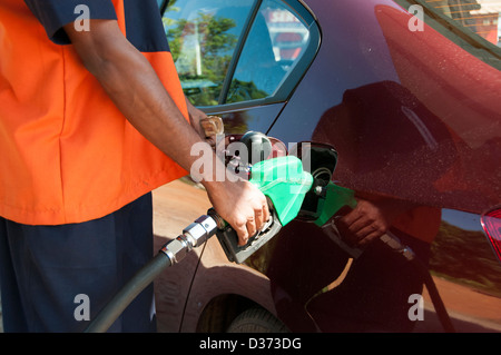 Filing a car with petrol in kerala, India Stock Photo