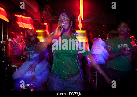 A supporter of the Opposition party and its newly elected President wearing the colours of the Patriotic Front and celebrating Stock Photo