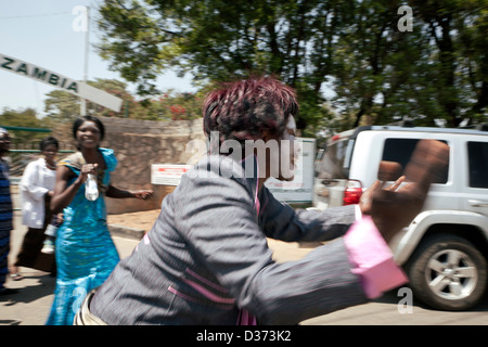 A jubilant supporter of the Opposition party the PF and its newly elected President Michael Sata dancing and celebrating Stock Photo