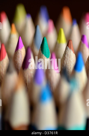 Close up photograph of brightly coloured pencils with a black background. Stock Photo