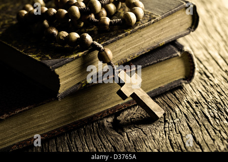 vintage rosary beads on old books Stock Photo