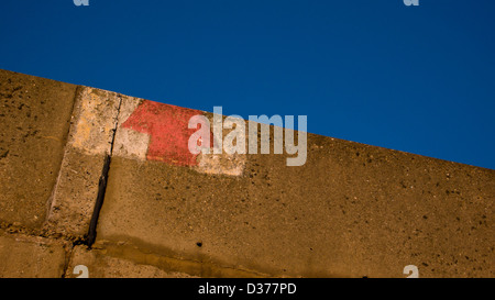 warning arrow painted on wall Stock Photo