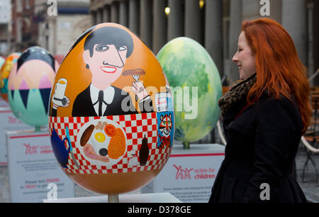 London, UK. 12th February 2013.  Catrin Mostyn Jones from North Wales encounters the face of Beatle Ringo Starr on one of the eggs. Over 100 giant Easter eggs designed by artists and designers were unveiled today in Covent Garden Piazza, London, to launch The Lindt Big Egg Hunt in support for the charity 'Action for Children'. For six weeks, from 12 February to 1 April 2013, giant Easter eggs will tour the country, from London's Covent Garden to Birmingham, Liverpool, Manchester, Glasgow and back to London in time for Easter. Photo: Nick Savage/Alamy Live News Stock Photo