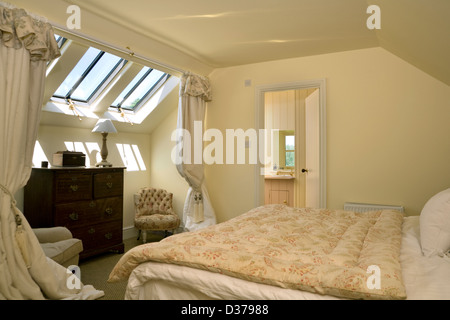 An attic bedroom with Velux windows. Stock Photo