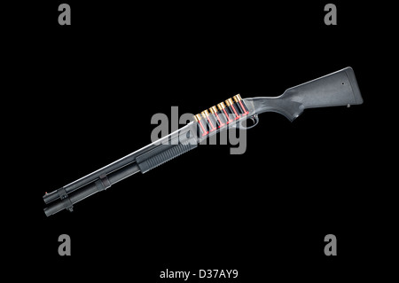 A pump action 12-gauge shotgun with red shells isolated on black. Stock Photo