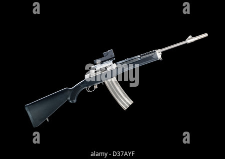 An assault rifle with a 30-round magazine isolated on a black background. Stock Photo