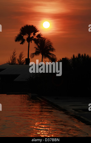 Beautifull tropical sunset at a swimming pool Stock Photo