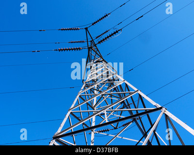 A electricity pylon against a blue sky Stock Photo