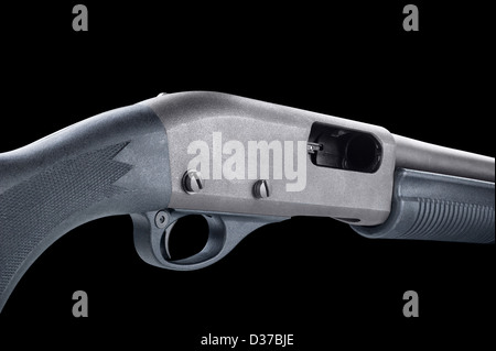 Close up of the trigger and ammo chamber of a modern pump action shotgun isolated on black. Stock Photo