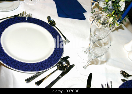 Dinner setting on white table cloth Stock Photo