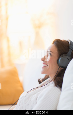 USA, New Jersey, Jersey City, Woman listening to music at home Stock Photo