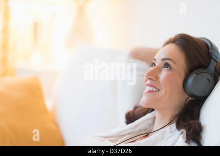 USA, New Jersey, Jersey City, Woman listening to music at home Stock Photo