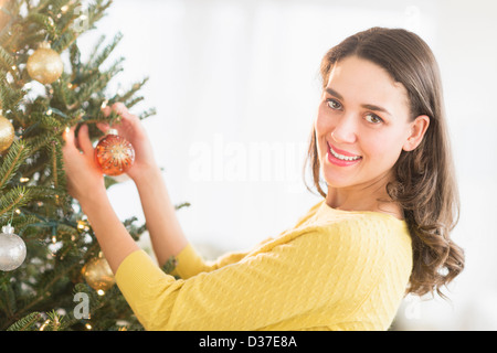 Woman decorating christmas tree Stock Photo