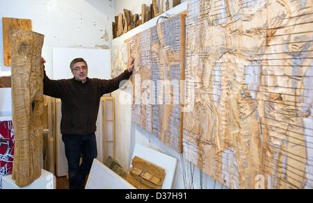 Sculptor Hans-Georg Wagner stands among his wooden artworks in his atelier in Cottbus, Germany, 28 January 2013. Photo: Patrick Pleul Stock Photo