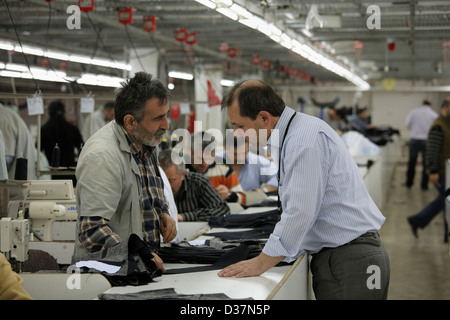 Istanbul, Turkey, people at sewing machines in a textile factory Stock Photo