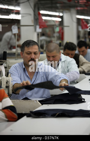 Istanbul, Turkey, people at sewing machines in a textile factory Stock Photo