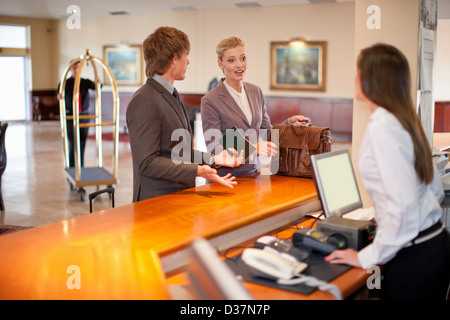 Businesswoman checking in to hotel Stock Photo