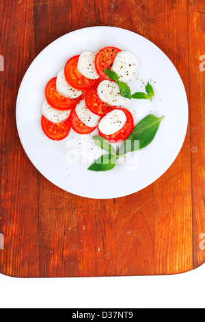 Mozzarella cheese tomato and basil on a plate Stock Photo