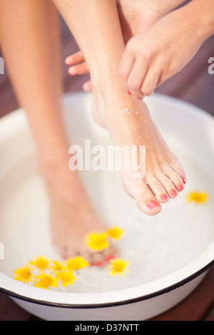 Woman having salt scrub on feet Stock Photo