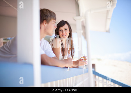 Couple drinking wine together on deck Stock Photo