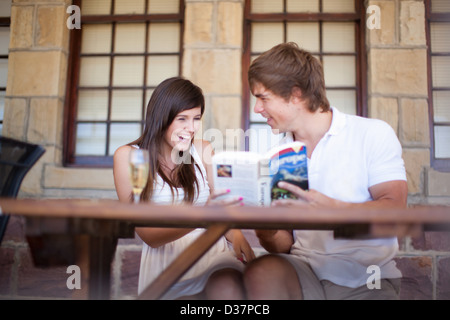 Couple reading travel book together Stock Photo