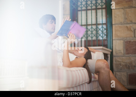 Couple relaxing on sofa together Stock Photo