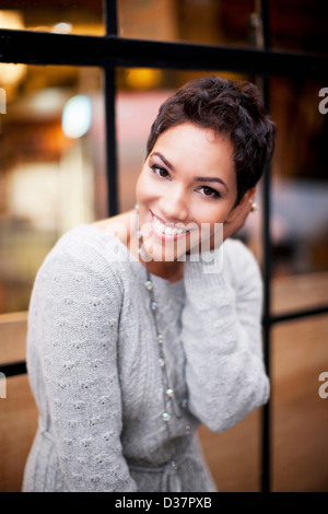 Woman smiling at window Stock Photo
