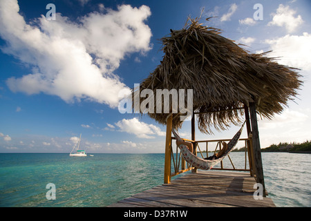 Woman in hammock on tropical water Stock Photo