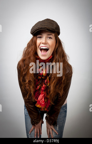 Laughing woman leaning on knees Stock Photo