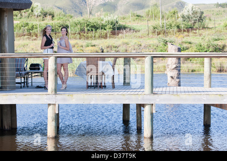 Women standing on wooden deck outdoors Stock Photo