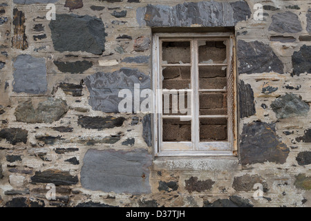 bricked up window, in a building's stone wall, Portsoy, Scotland. Stock Photo