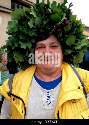 Latvians with summer wildflower wreath and National folklore costumes during Midsummer summer solstice celebration in Latvia, Baltic region, Europe. Stock Photo