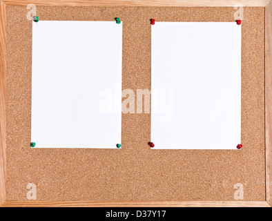 two white sheets of paper on cork board in wooden frame Stock Photo
