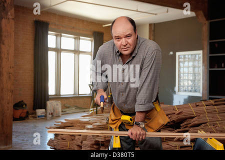 USA, Texas, Dallas, Man cutting piece of plank Stock Photo