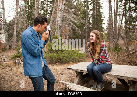 USA, Utah, Salt Lake City, young man photographing his girlfriend in non-urban scene Stock Photo
