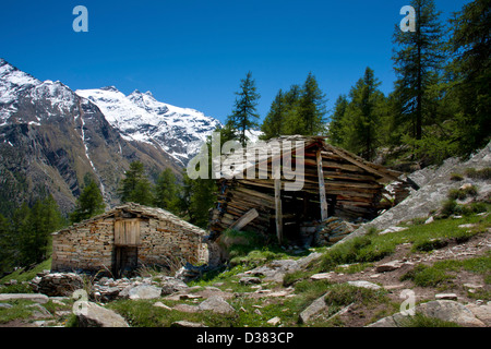 Old wood and stone farmsteads in Gran Paradiso National Park, between Piedmont and Aosta valley, Graian Alps, Italy Stock Photo