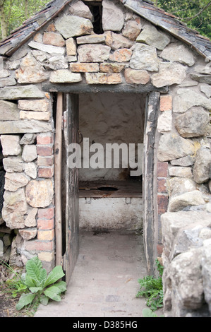 Old outside toilet privvy loo bog end of yard Stock Photo