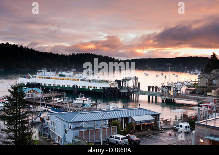 A Washington State Ferryboat arrives at the dock to unload autos and passengers to the town of Friday Harbor on San Juan Island. Stock Photo