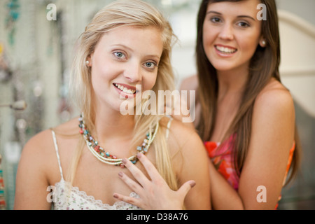 Woman trying on jewelry in store Stock Photo