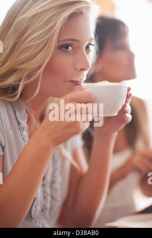 Woman with milk mustache in cafe Stock Photo