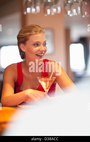 Woman having drink at bar Stock Photo