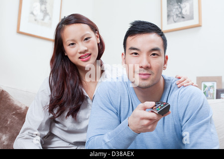 Couple watching television together Stock Photo