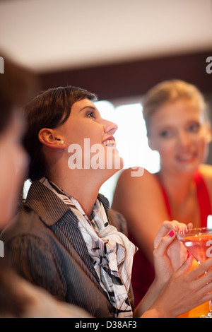 Women having drinks together at bar Stock Photo