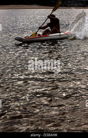 Man rowing kayak in lake