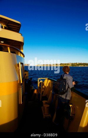 A passenger on the Sydney Ferry crossing the Sydney harbor Stock Photo