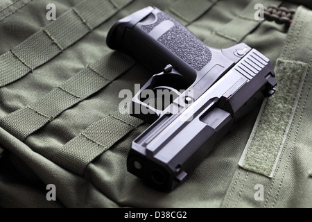 Weapon series. European 9mm semi-automatic USP Compact pistol on a green background. Studio shot. Stock Photo